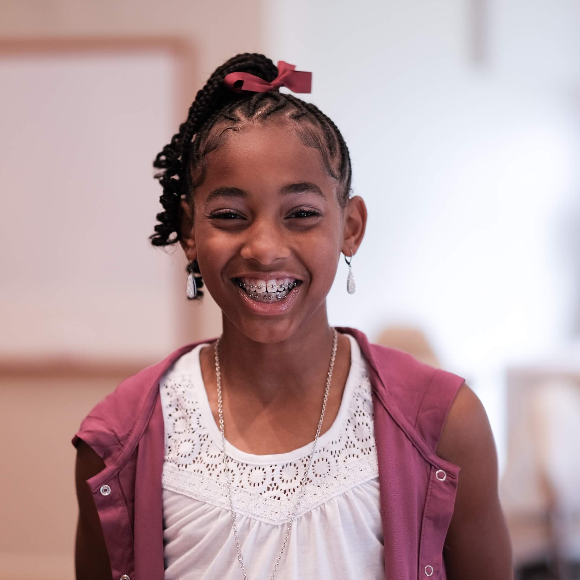 A photo of a smiling young girl with braces