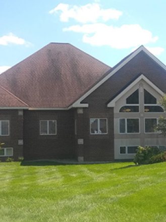 The image of a building with a dark brown roof and the same walls colors