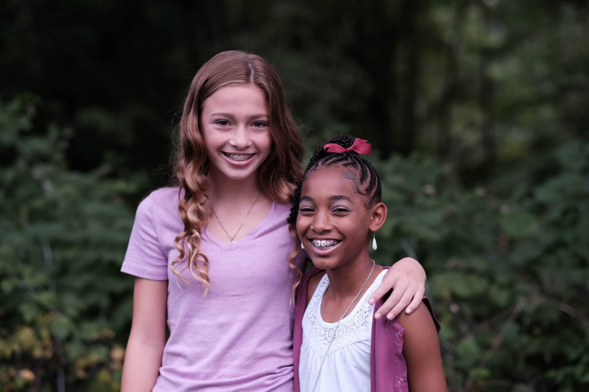 A photo of smiling two girls with braces