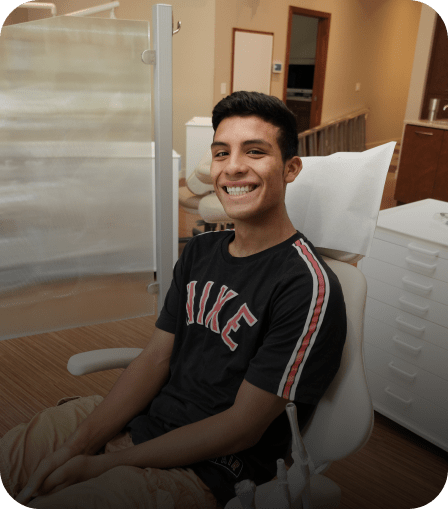 A boy smiling in the dentist's chair at Bandee Northo's office