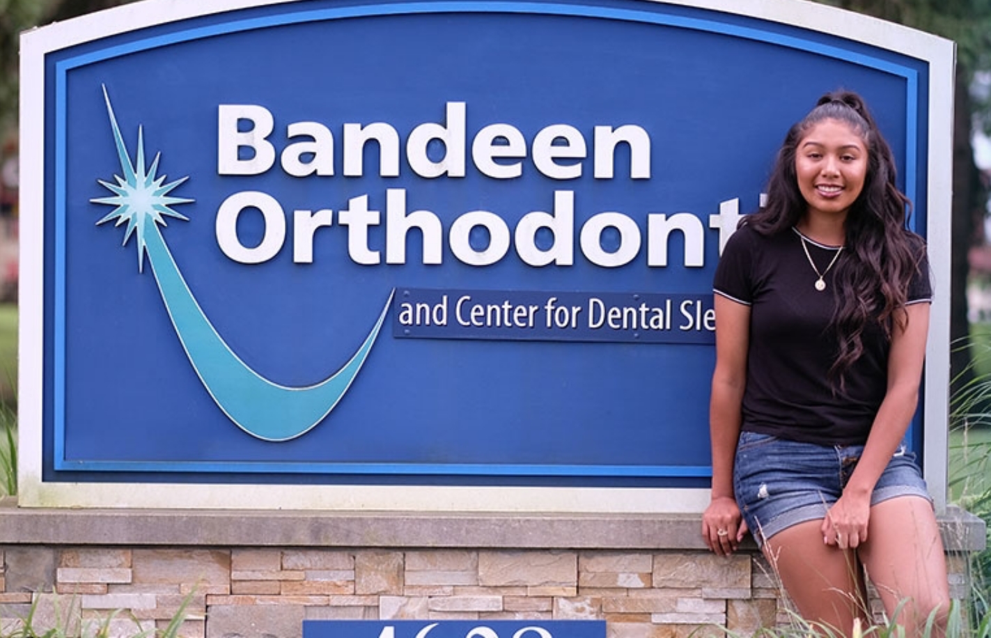 The photo young girl smiling with Bandeen Orthodontic logo