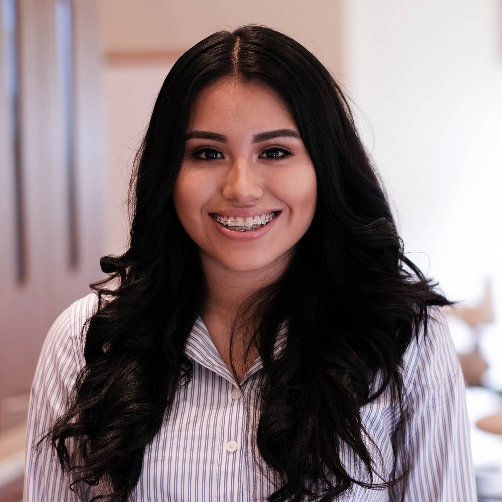 The image of the woman smilling with braces